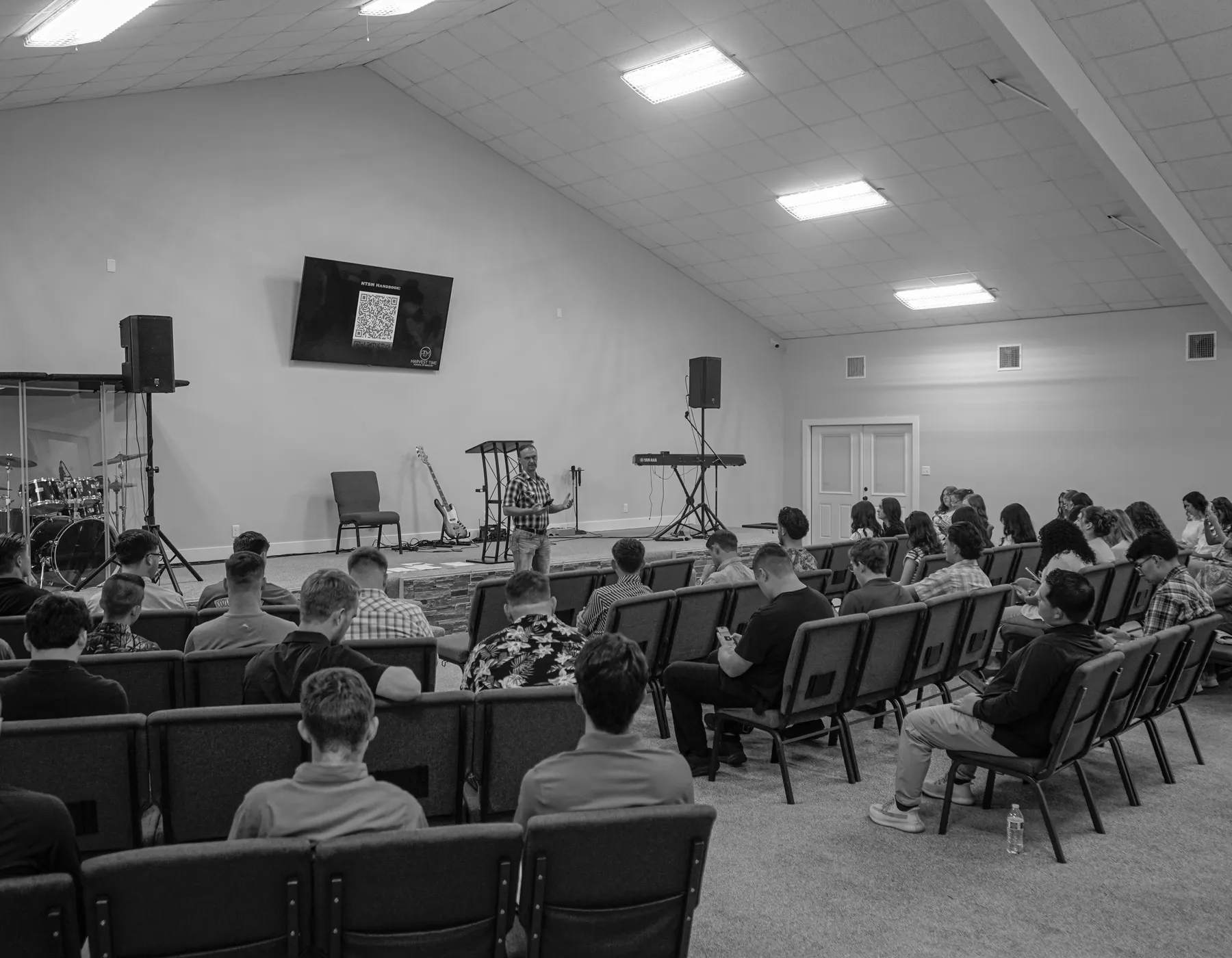 Pastor Matt Gregory teaching a full classroom at Harvest Time School of Ministry
